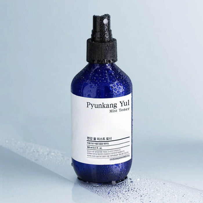 PYUNKANG YUL Mist Toner 200ml bottle with water droplets on a smooth surface.