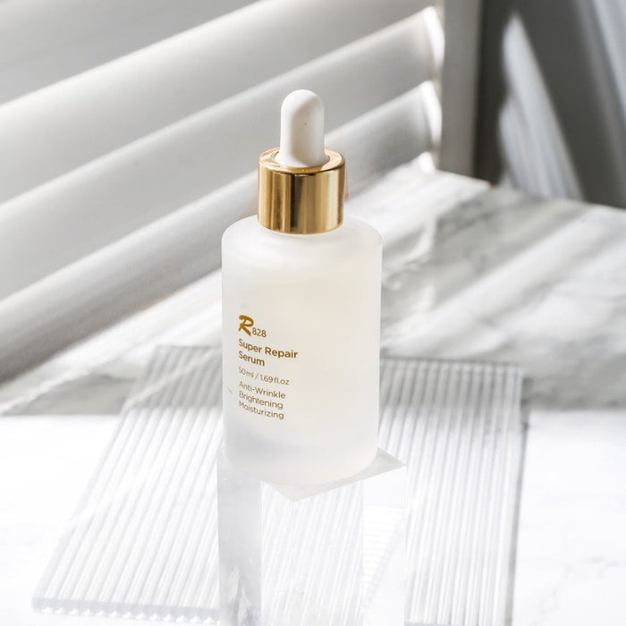 R828 Super Repair Serum 50ml bottle on a white background with a dropper, highlighting its anti-wrinkle and moisturizing benefits.