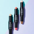 Three shades of RIRE Luxe dual Stick makeup on a pastel background highlighting versatile cosmetic options.
