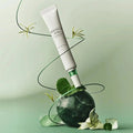 SKIN1004 Madagascar Centella Tea-trica Spot Cream 20ml displayed creatively with green and floral elements.