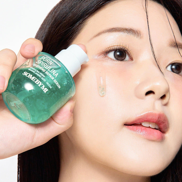 Woman applying SOME BY MI PDRN Spirulina Soothing Repair Serum 50ml to her face for skin repair and soothing