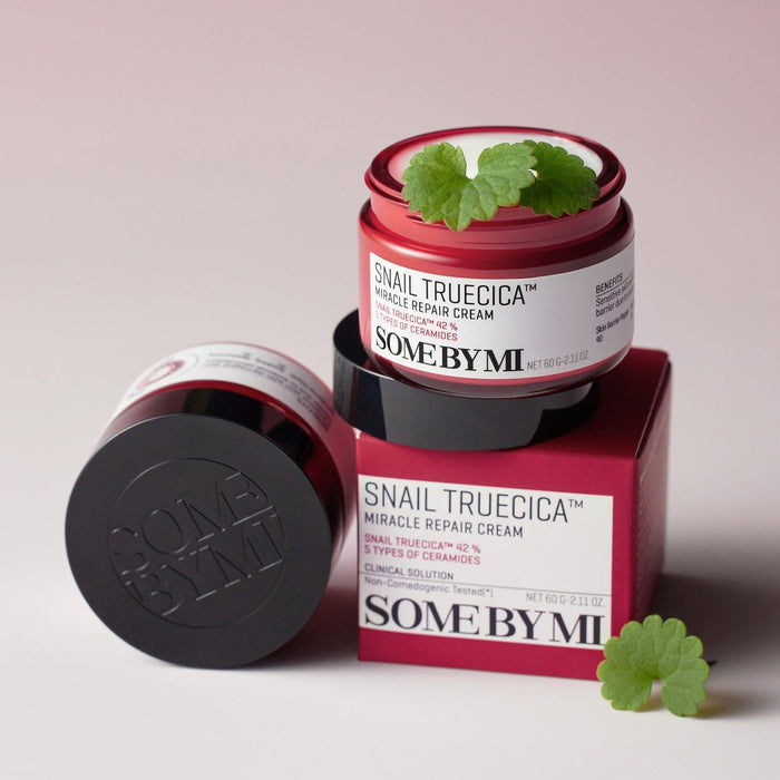 SOME BY MI Snail Truecica Miracle Repair Cream 60g open jar on red box with plant leaves, enhancing skin rejuvenation and repair.