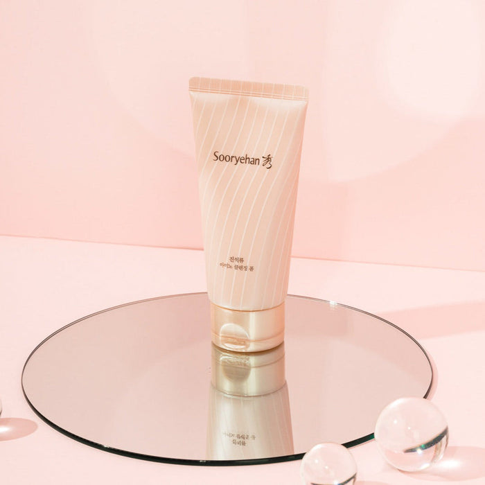 SOORYEHAN Jinseokryu Amino Cleansing Foam 160ml product displayed on a mirror with a soft pink background.