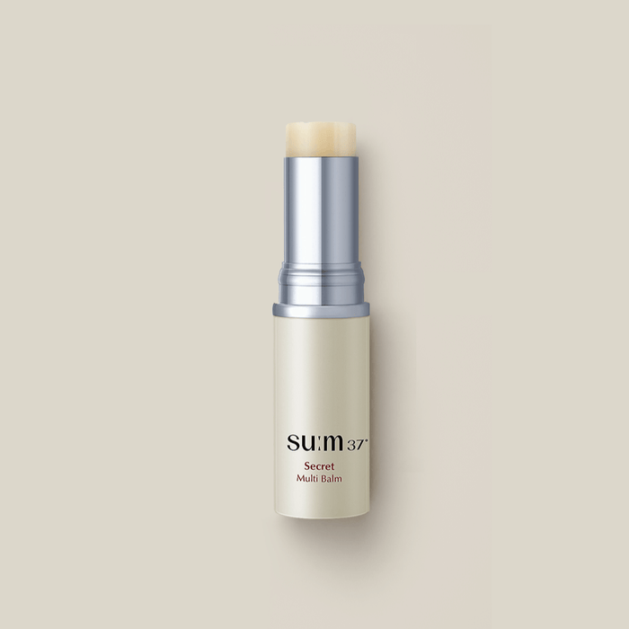 SU:M37 Secret Multi Balm 7g displayed on a beige background, highlighting its sleek design and compact size.