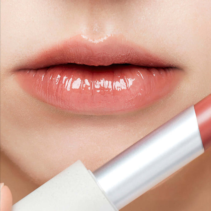 Close-up of lips wearing SU:M37 Skin-Stay Glossy Lip Balm for smooth, shiny finish.