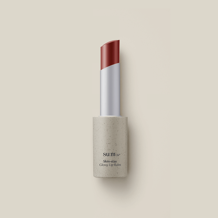 SU:M37 Skin-Stay Glossy Lip Balm in a sleek tube, offering a hydrating and shiny finish for lips.