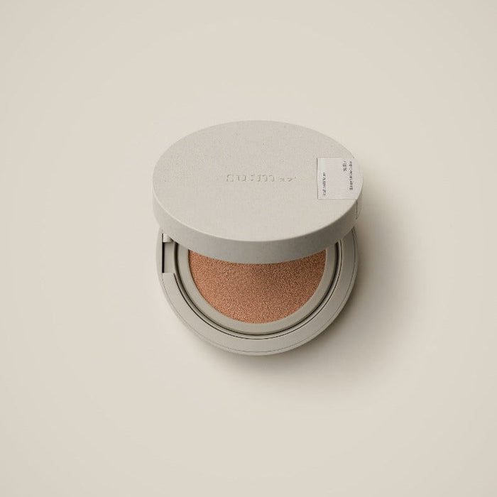 SU:M37 Skin-Stay Soft Glow Cushion in open compact case on soft beige background