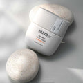 SU:M37 Sun-Away Airfit Sunquid 50+/PA++++ 50ml sun protection product image on a textured background.