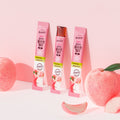 TEAZEN Kombucha Collagen Jelly Peach 14 Sticks on display with fresh peach background