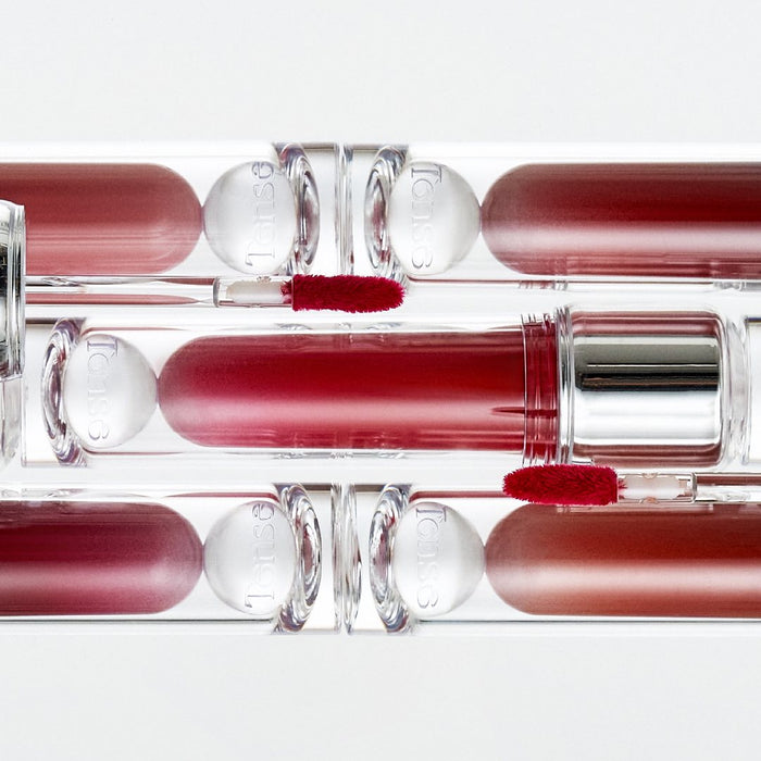 TENSE Shine Moment Glossy Tint in various shades and sleek packaging displayed on a white background.