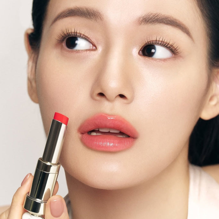 THE WHOO Essentail Lip Glow Balm applied by a model, showcasing vibrant lip shade for a natural look.