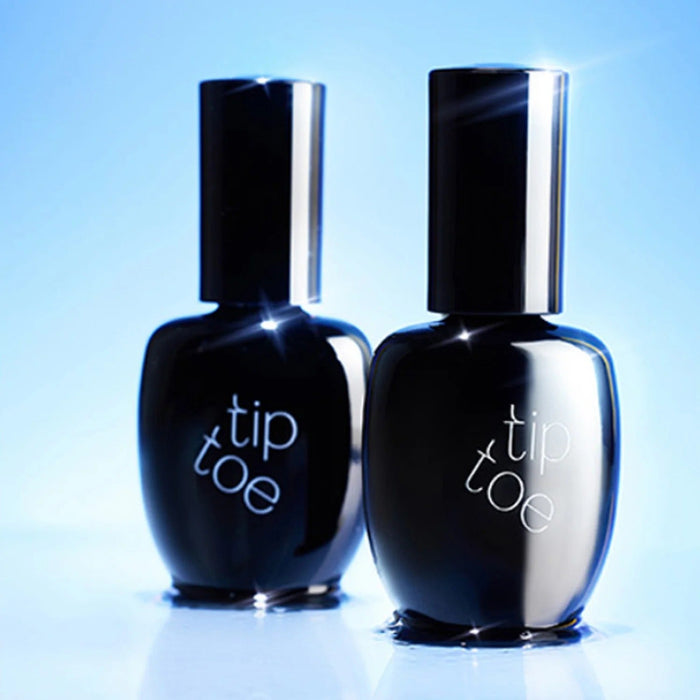 Two bottles of TIP TOE Sheer Topcoat Nail Polish on a reflective surface.