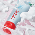 TOCOBO Coconut Clay Cleansing Foam with vegan label, creamy texture and bubbles on pink surface