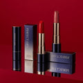 TONY MOLY Perfect Lips Rouge Intense lipsticks displayed with packaging on a red background.