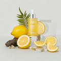 TONYMOLY 2X Vitamin C Toning Ampoule 50ml with fresh lemon slices displayed on a clear surface for vibrant skincare enhancement.