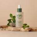TONYMOLY Trugreen White Truffle Calming Oil 50ml bottle with natural accents, promoting a vegan product line on a wooden and plant backdrop.