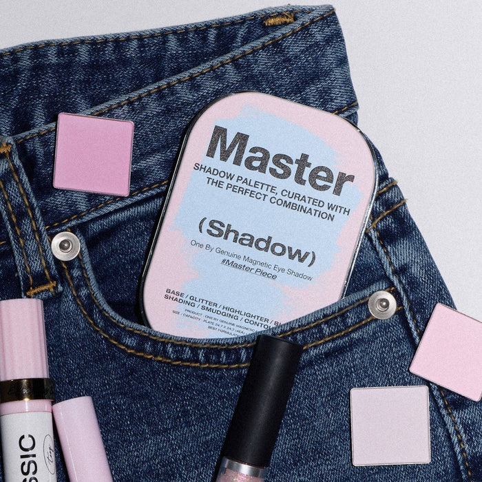 TOOQ Master Piece Face Shadow Palette nestled in denim with makeup accessories and pink eyeshadow squares.