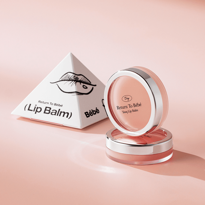 TOOQ Return To BÃ¨bÃ¨ Lip Balm in elegant packaging, featuring a sleek pink container and eye-catching design.