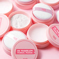 TOUCH IN SOL No Poreblem Mineral Powder 5g displayed in open containers with application puffs on a pink background.