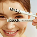 UNLEASHIA Pretty Easy Glitter Stick held by a smiling person showcasing the product's sleek design and glitter application.