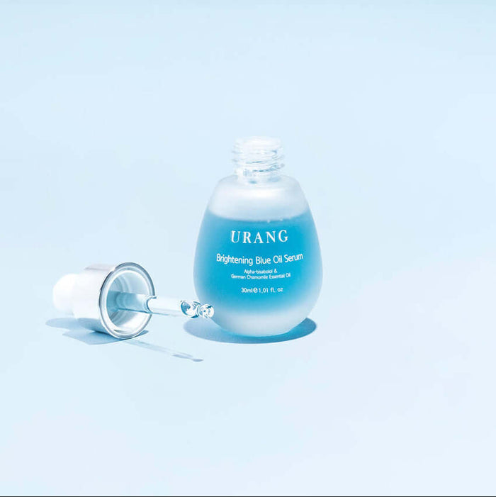URANG Brightening Blue Oil Serum 30ml bottle with dropper on light blue background.