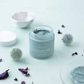 URANG Clarifying Blue Mask jar surrounded by decorative elements on a light background.
