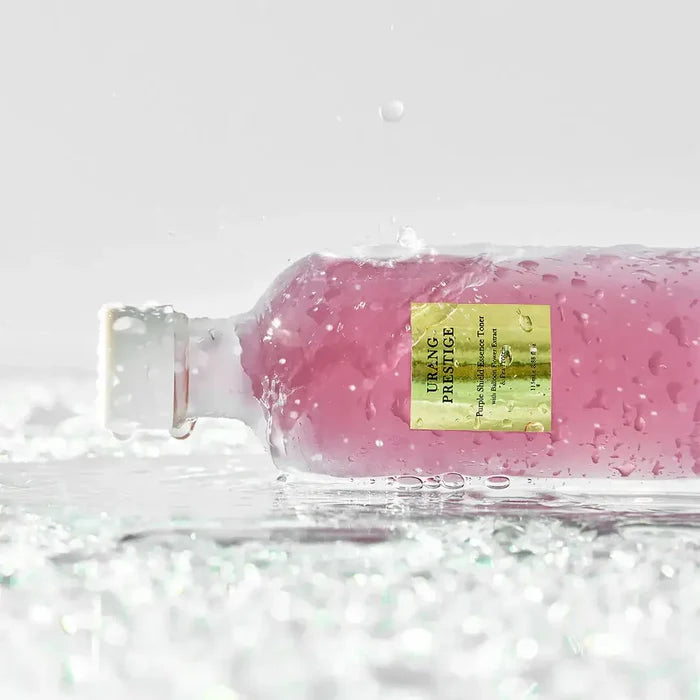 URANG Prestige Purple Shield Essence Toner bottle on wet surface with water droplets