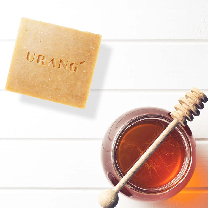 URANG Sweet Honey & Milk CP Handmade Soap next to jar of honey on white background