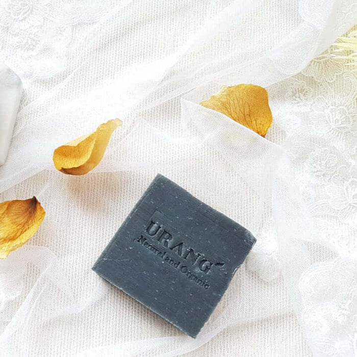 URANG Troubleshooter CP Handmade Soap on lace cloth with rose petals, highlighting natural and organic skincare benefits.