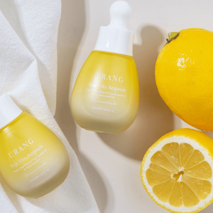 URANG Yuja Vita Ampoule with fresh yuja fruit on white background, highlighting its natural vitamin-rich formula for radiant skin.