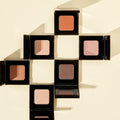 Collection of VIDIVICI Single Eye Shadow in various shades, neatly arranged in a cross pattern on a light background.