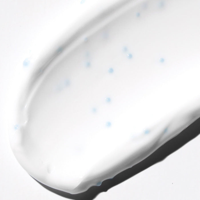 Texture of VT COSMETIC PDRN Cream RX 60ml showing moisturizing cream with blue microbeads on a white background.