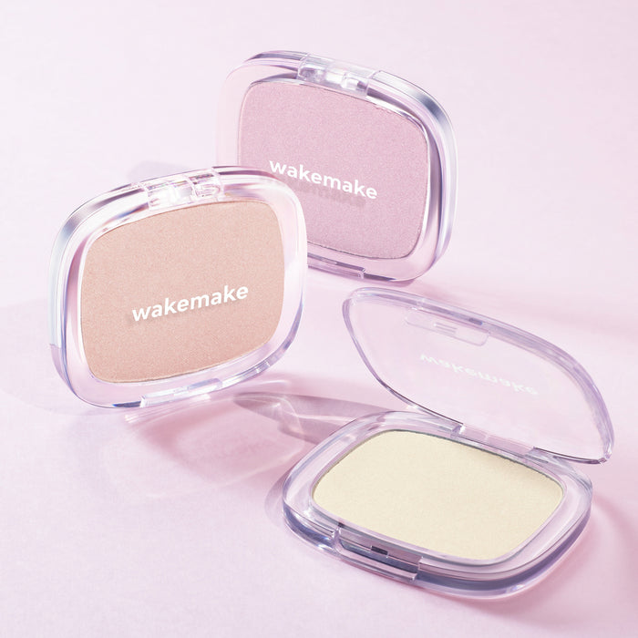 Three WAKE MAKE Sheer Breeze Highlighter 5g compacts in different shades on a pink background.