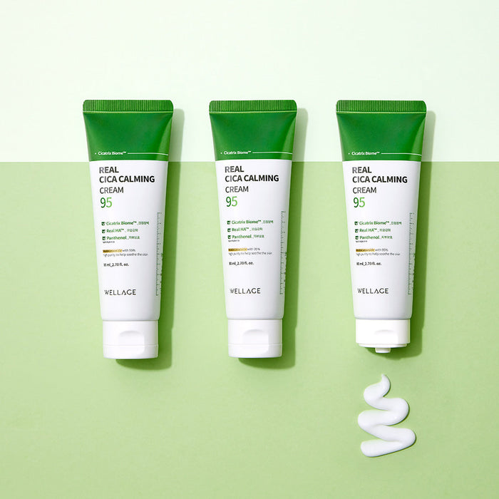 WELLAGE Real Cica Calming 95 Cream 80ml tubes on a green background with cream texture.