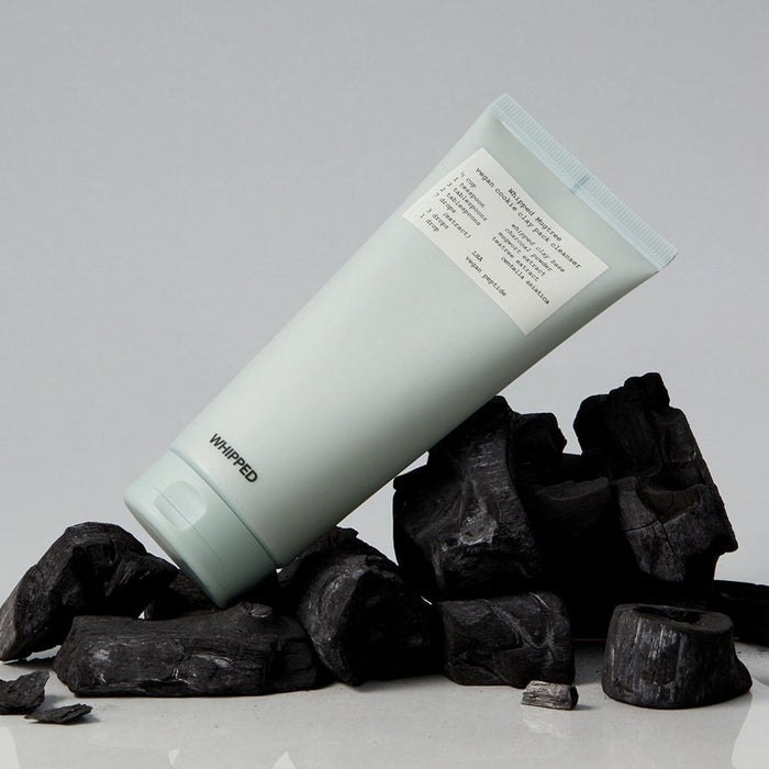 WHIPPED Mugtree Vegan Cookie Clay Pack Cleanser 180ml product on display with charcoal background.