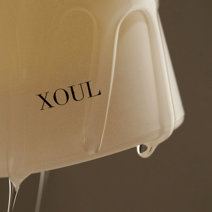 Close-up view of XOUL Pure Cell Cleansing Gel 130ml bottle with gel flowing, showcasing the product's texture and branding.